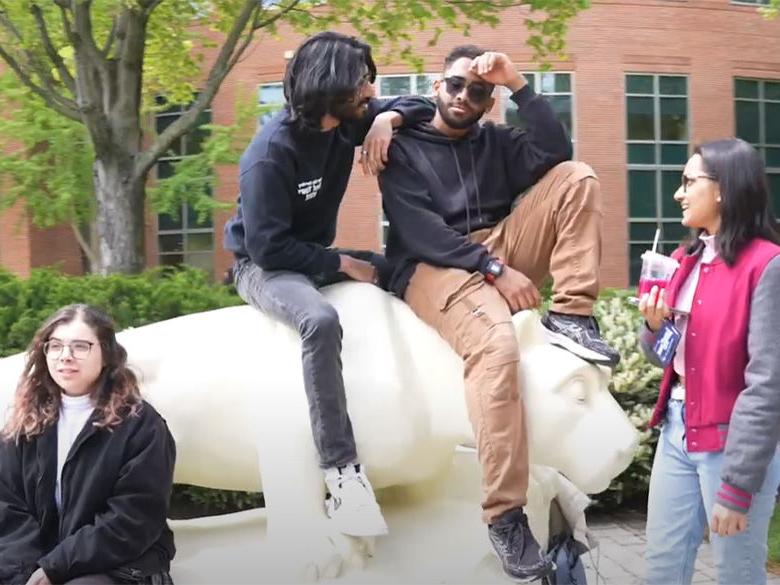 students hanging out around lion shrine